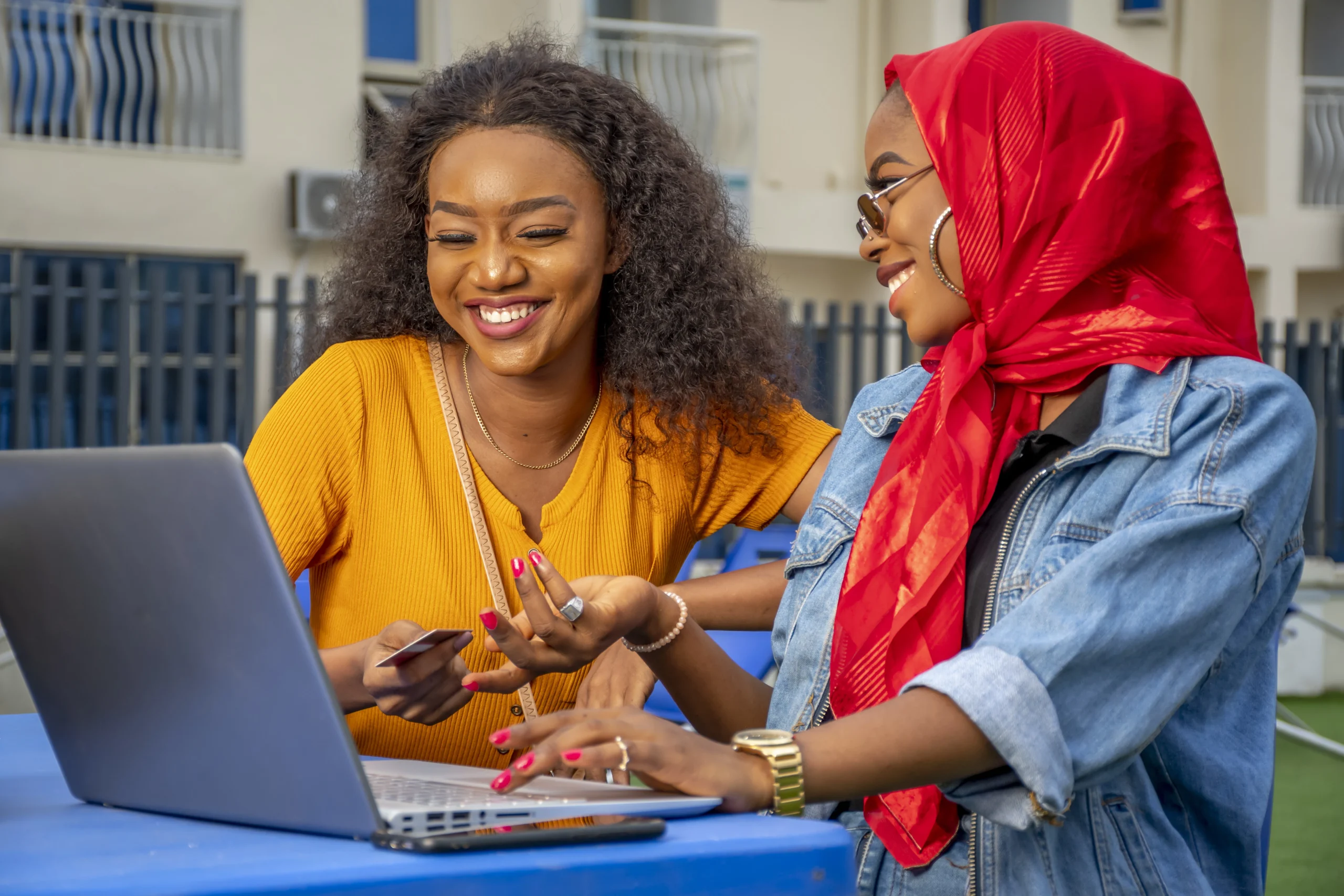 closeup-shot-two-cheerful-young-african-ladies-laptop (1)